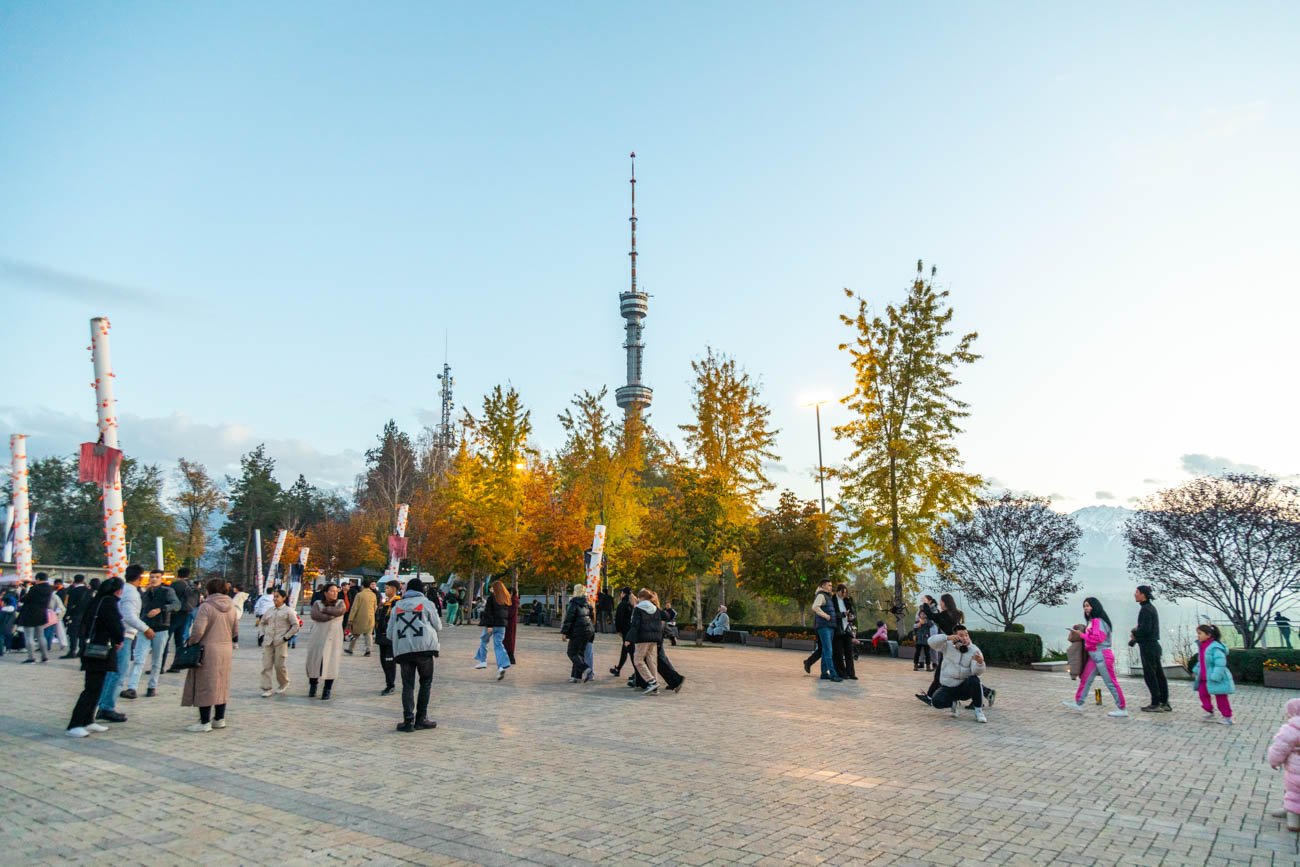 Almaty, Kazakhstan - April 28, 2023: Television Tower of Almaty city on Kok-Tobe hill with walking tourists